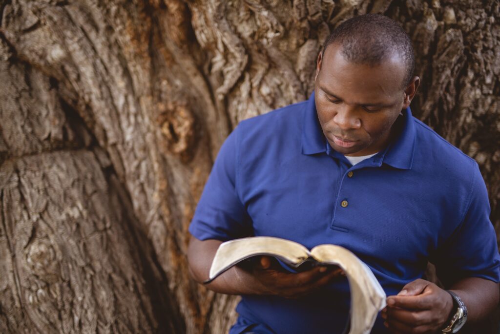 A man reading Bibble -Biblia na Kanisa